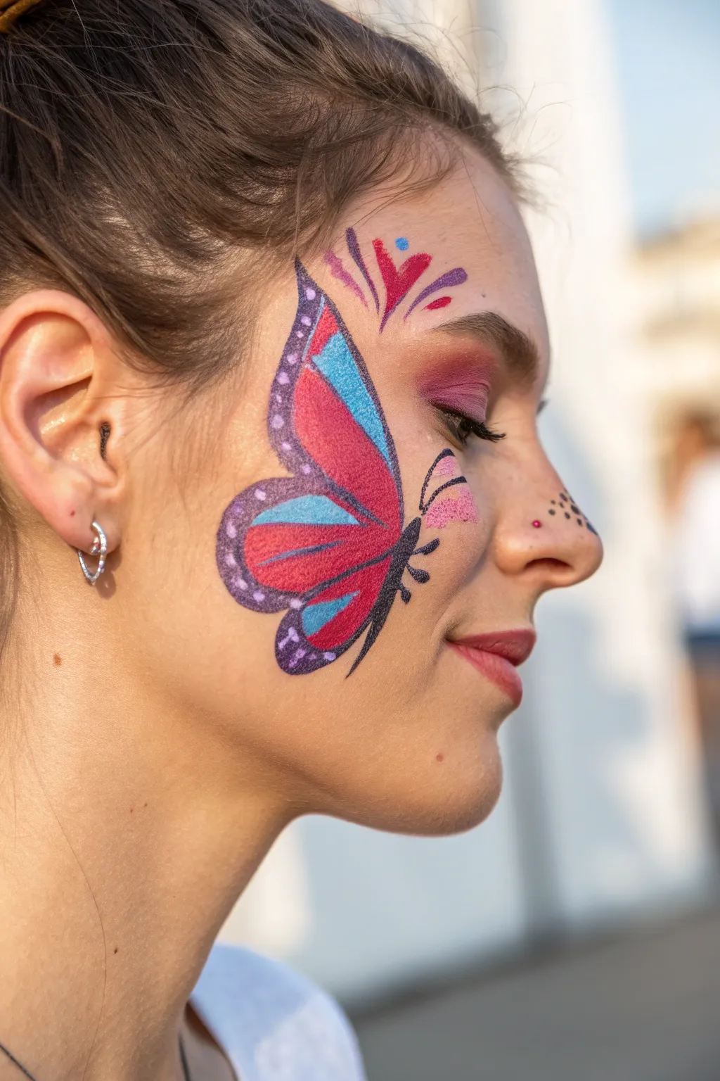 Embrace the summer with a burst of color and whimsy. Let your creativity take flight with a stunning butterfly face paint design!