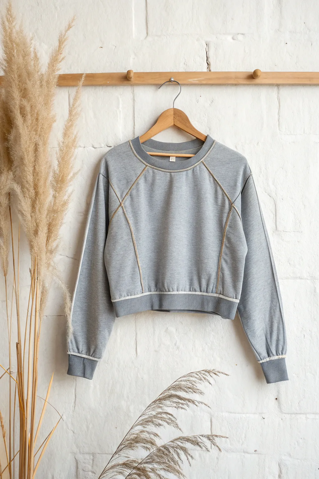 Transform your old sweatshirt into a chic crop top for a fresh, trendy look.
