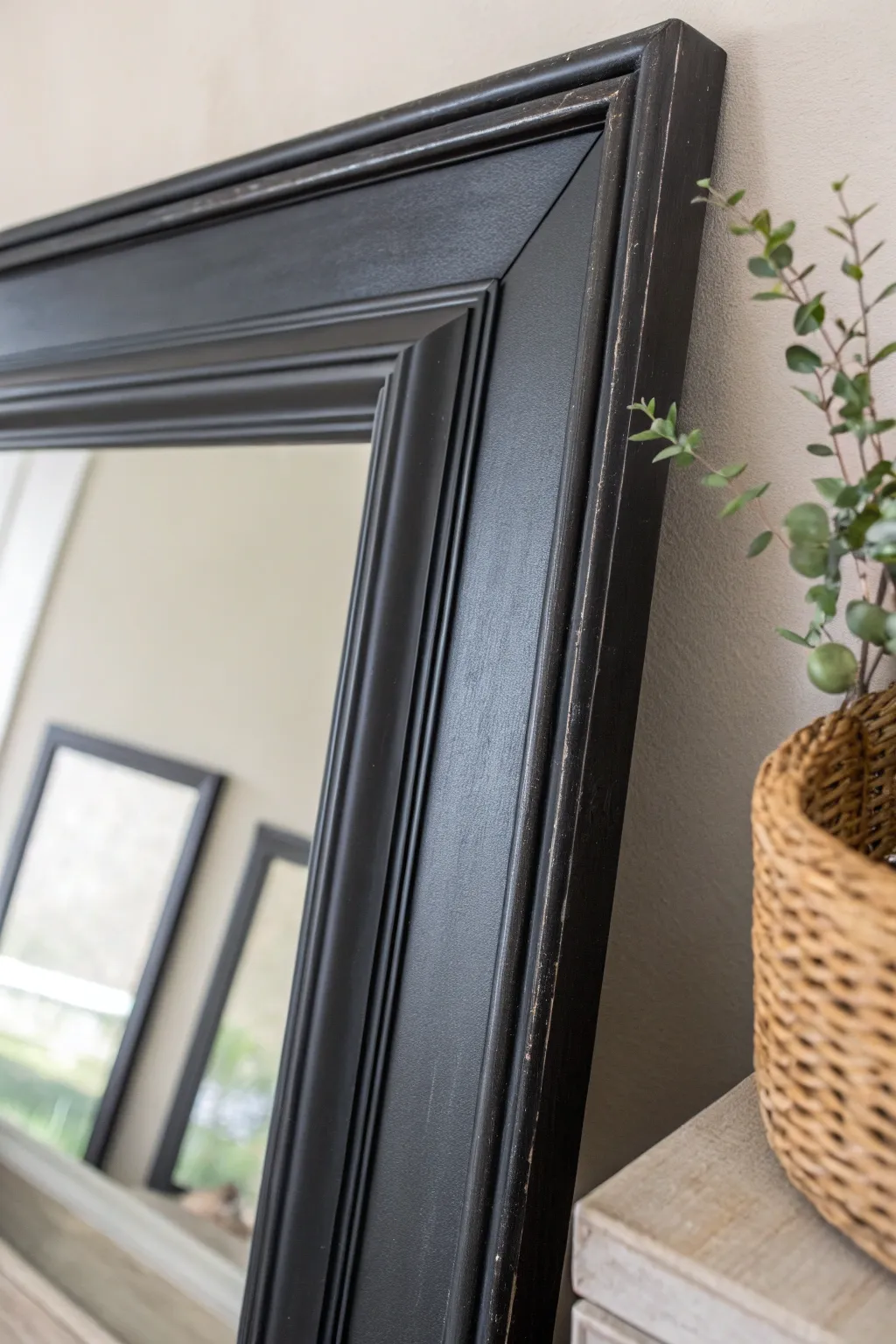 Transform your space with the sleek sophistication of a black chalk-painted mirror frame. #MonochromeMagic