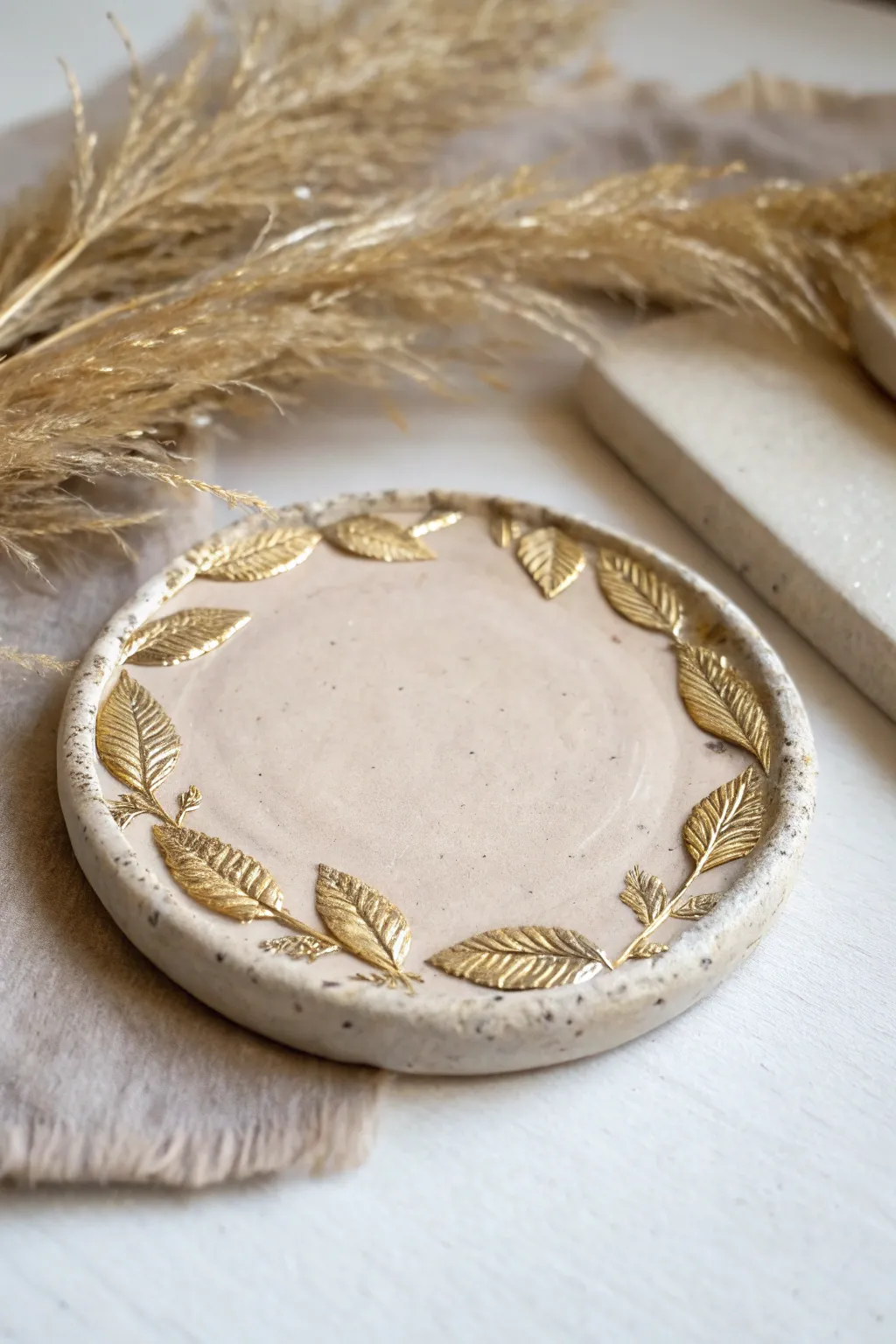 Elevate your table setting with a touch of gold – handcrafted clay coasters with chic metallic accents.