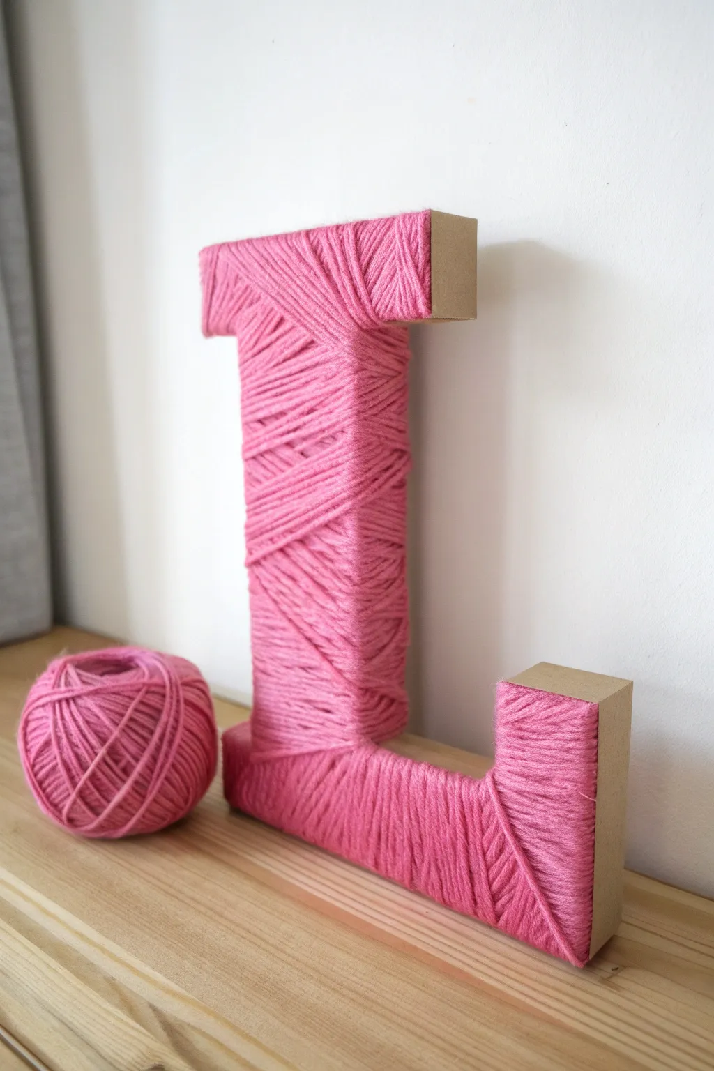 Celebrate love with handcrafted elegance: Yarn-wrapped letters that add a pop of color and warmth to your space.