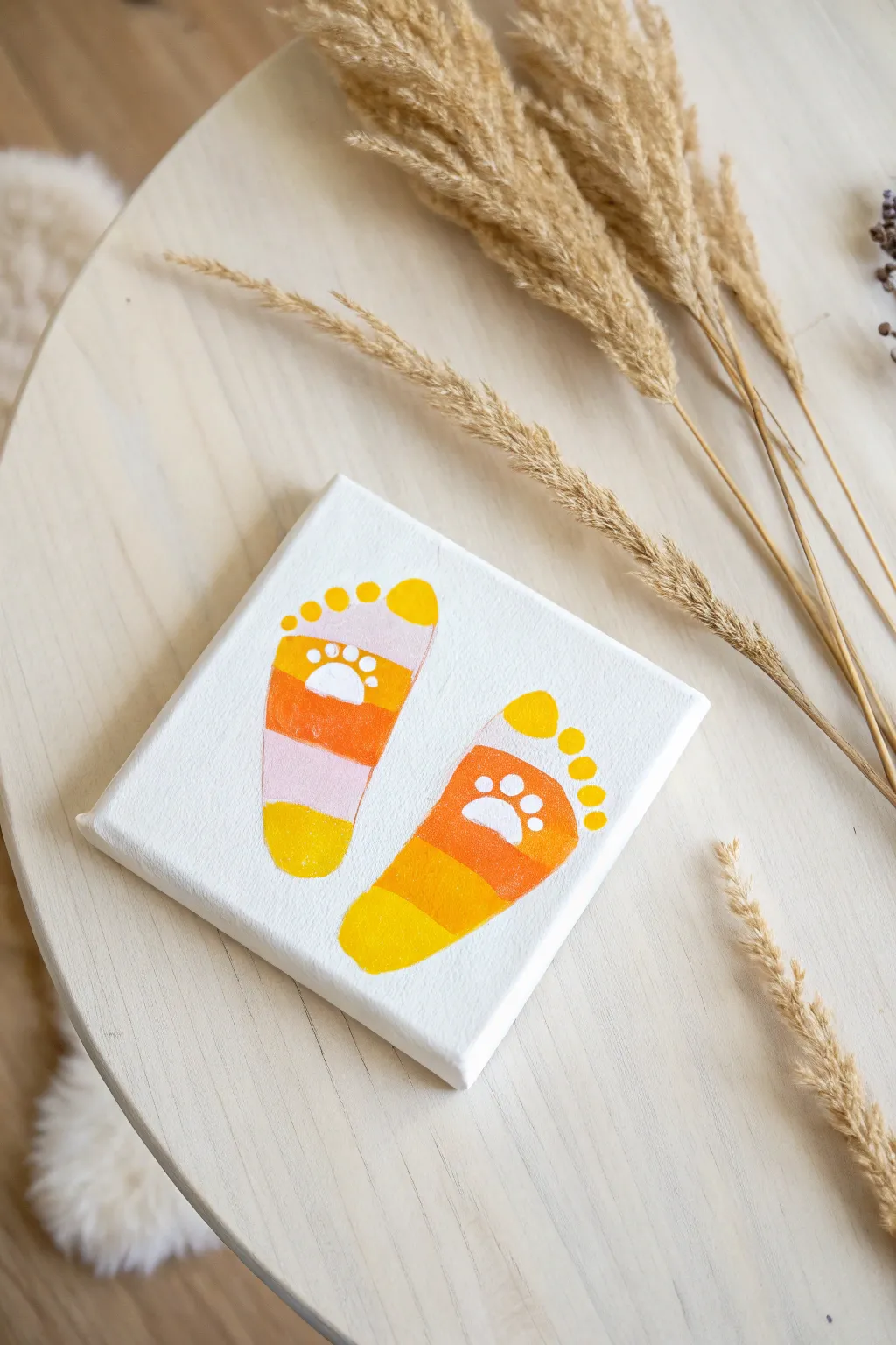 Tiny toes, big memories! Capture Halloween magic with these adorable candy corn footprints. 🎨👣 #HalloweenCrafts #BabyMemories