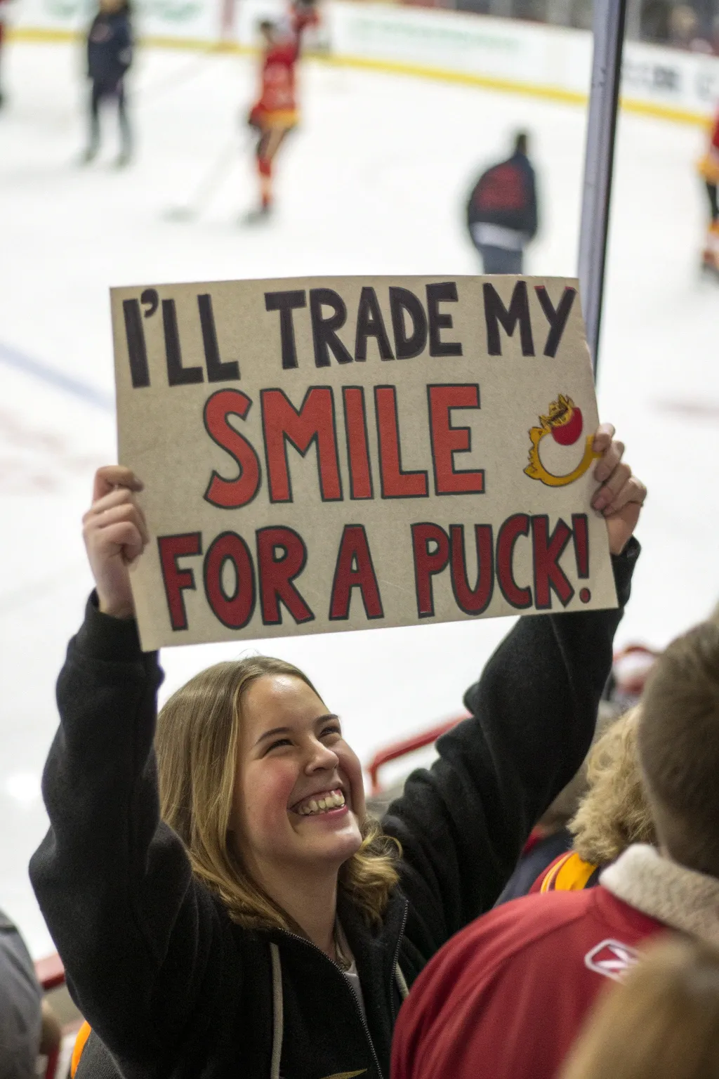 Score big with a smile and a clever sign. #HockeyFanGoals