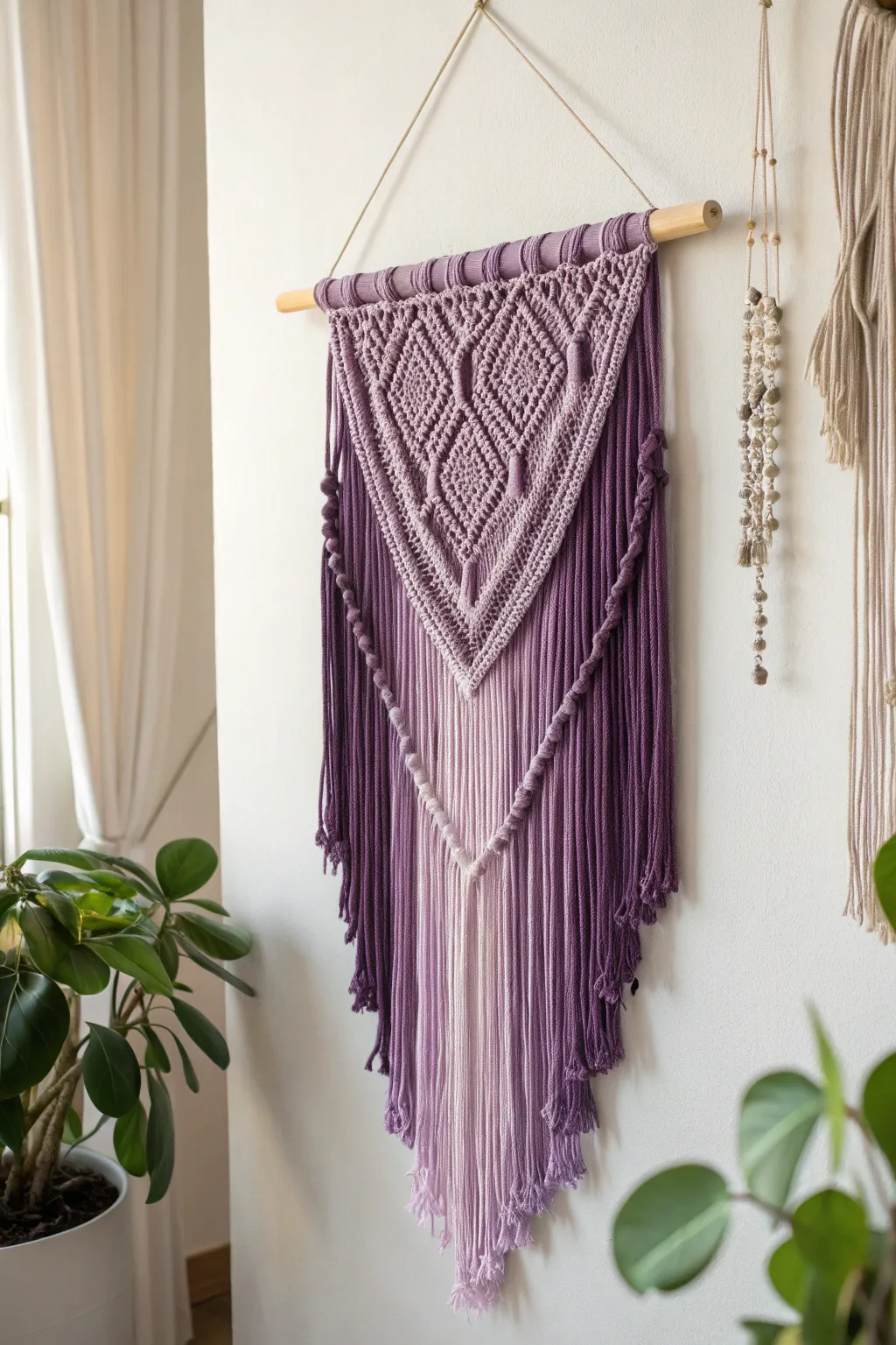 Add a touch of boho elegance to your space with this stunning purple yarn wall hanging.