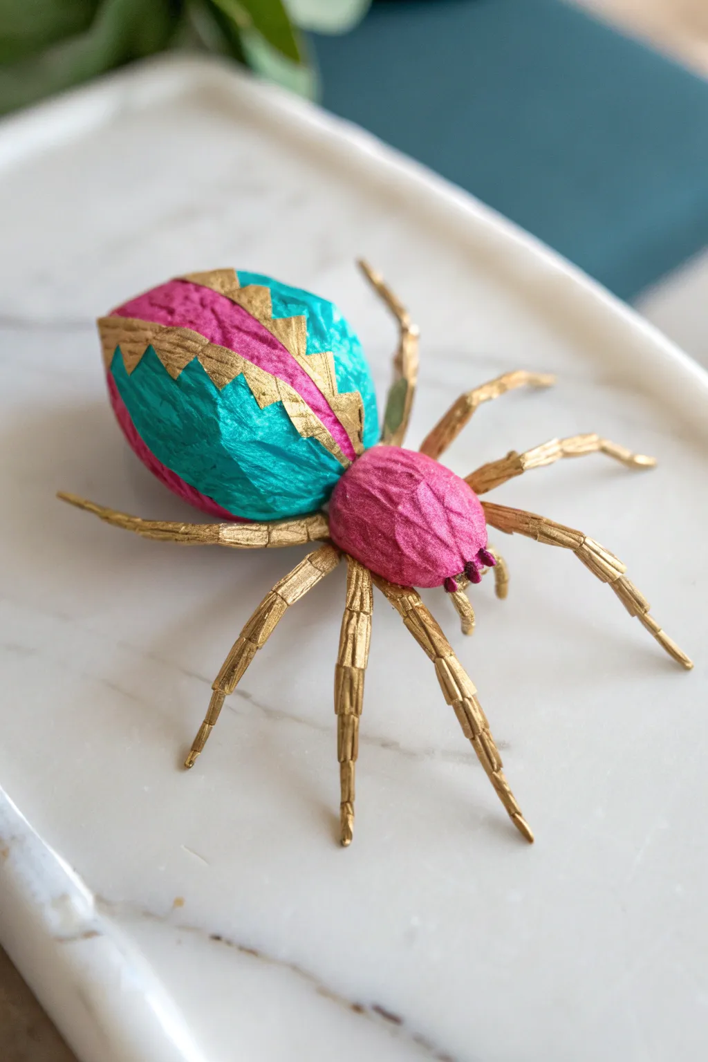 A playful twist on spider crafts with vibrant tissue paper elegance.