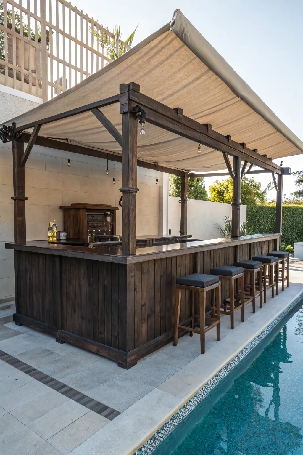 Craft your perfect poolside retreat with this elegant shaded bar setup.