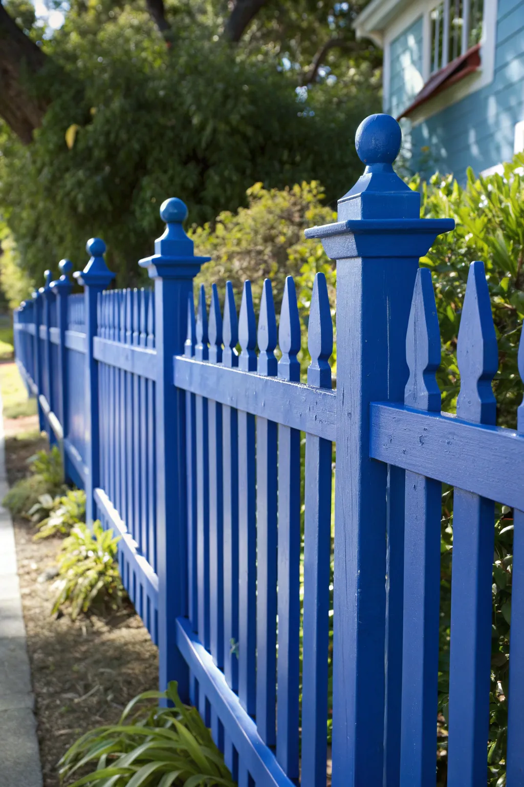 Transform your outdoor space with a splash of color: Embrace the bold elegance of a royal blue picket fence.