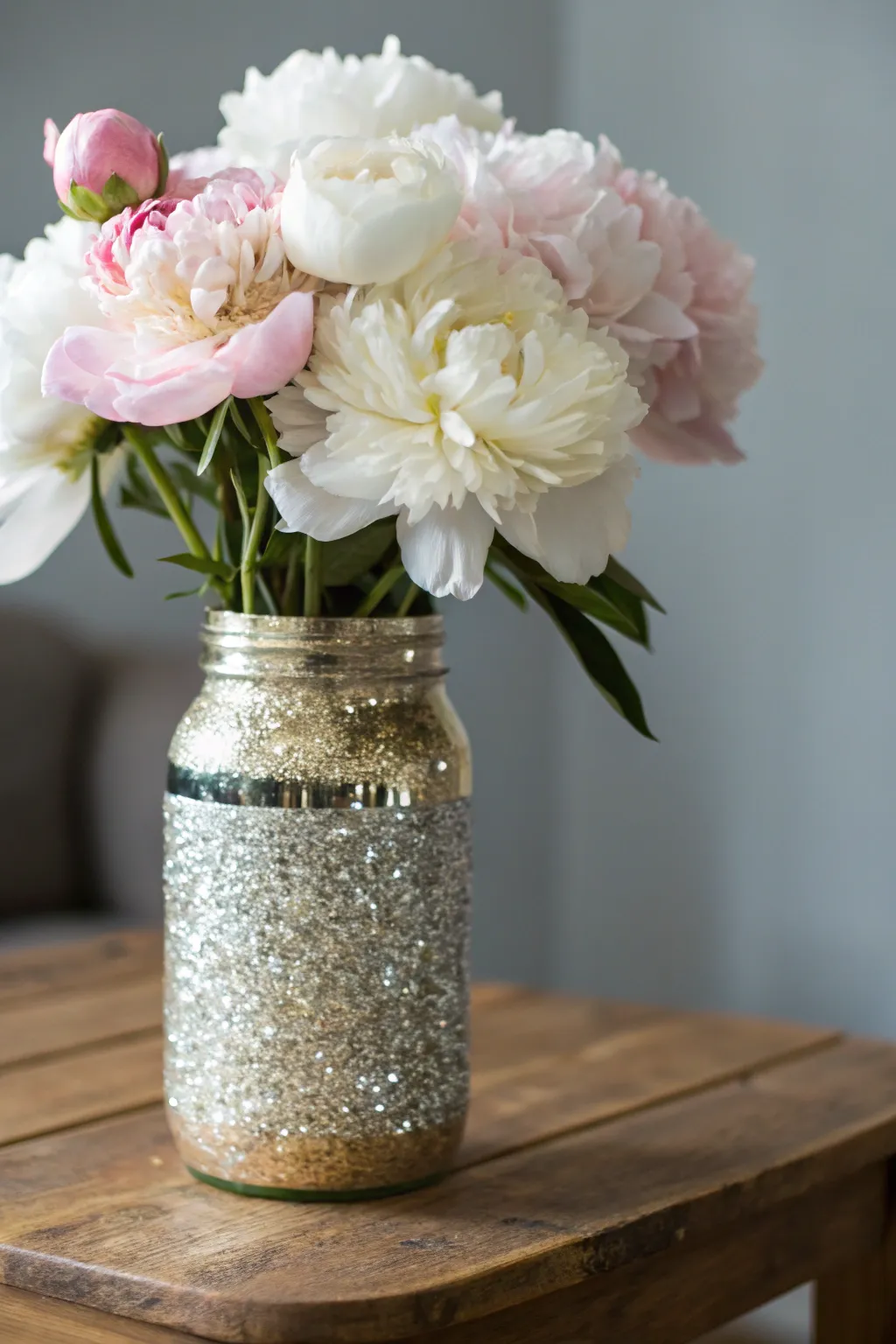 Add a touch of sparkle and elegance to your space with these glittery mason jar vases. Perfect for showcasing your favorite blooms in style.