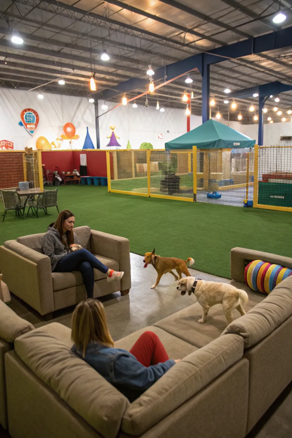 Relaxing seating areas enhance the indoor dog park experience for owners.