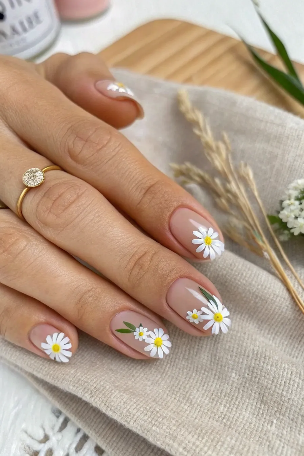 Elevate your classic French manicure with charming daisy tips for a fresh, minimalist look.