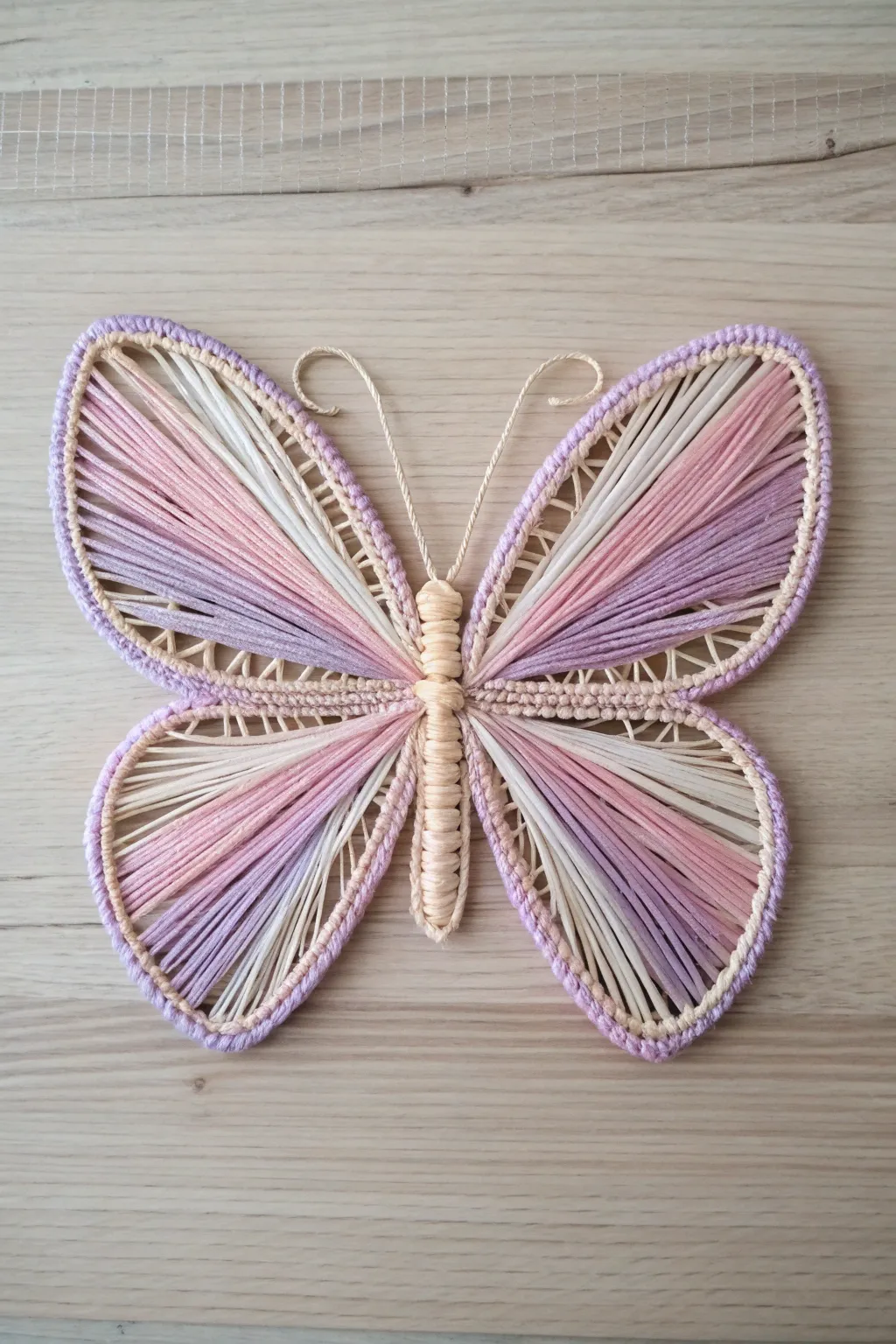 Embrace nature's charm indoors with a string-crafted butterfly, where simplicity meets bohemian elegance.