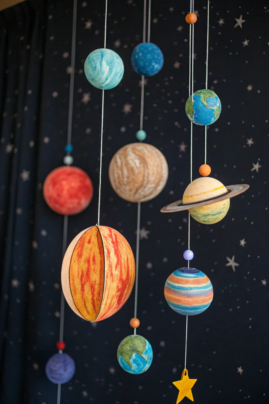 Explore the universe from your room with this handcrafted paper plate solar system mobile!