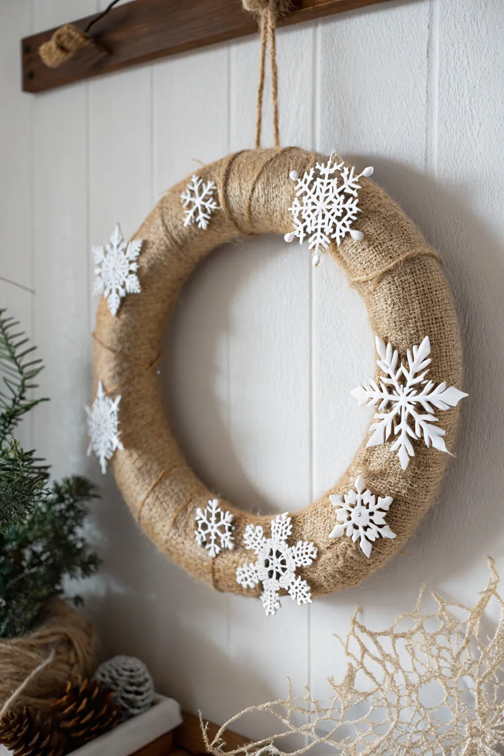 Embrace the serenity of winter with this snowflake-adorned burlap wreath, perfect for a tranquil holiday decor.