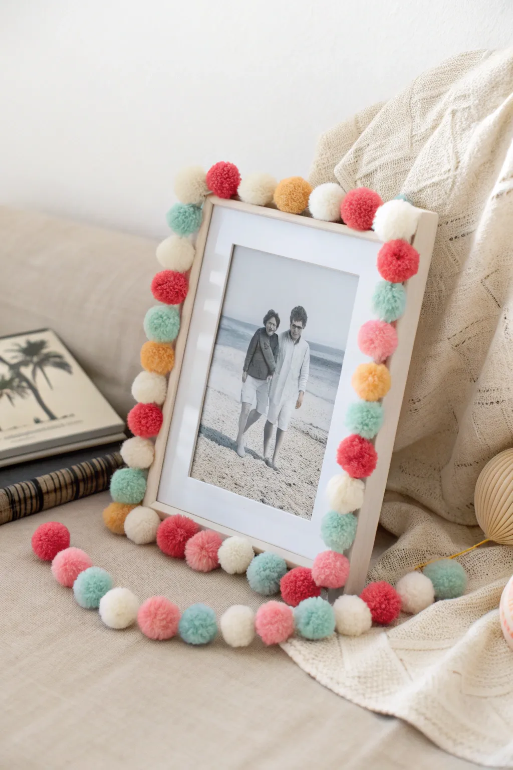 A touch of whimsy meets Scandinavian simplicity: Transform your photo frames with charming pom pom accents.