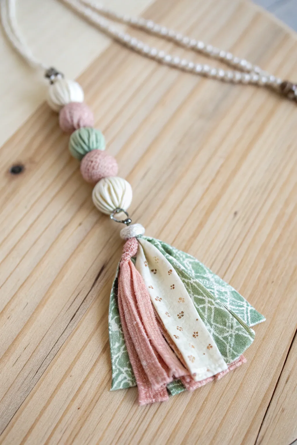 Embrace elegance with a touch of boho flair: Discover the beauty of layered fabric pendants.