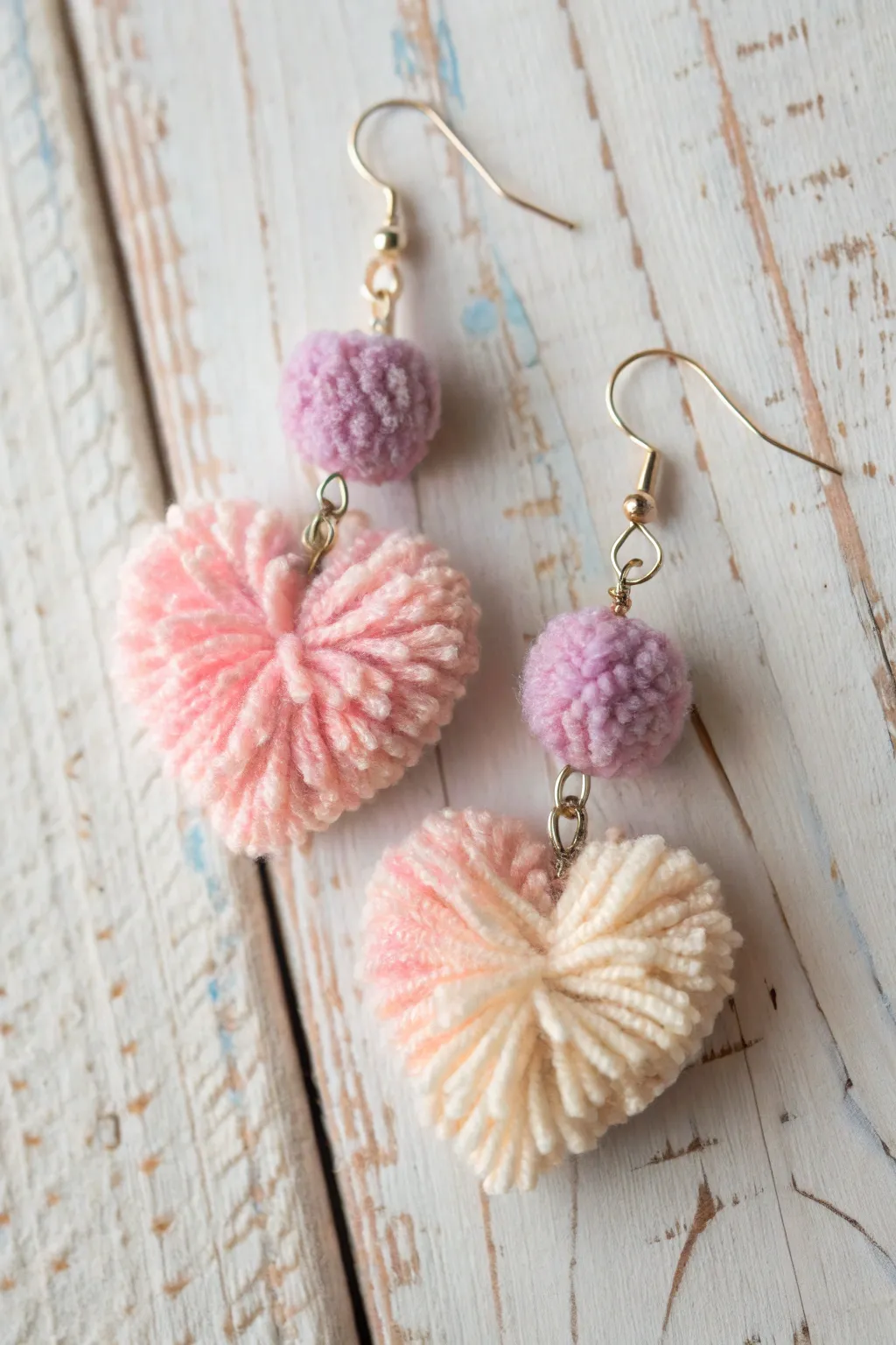 Add a touch of handcrafted elegance to your look with these charming pom-pom heart earrings.