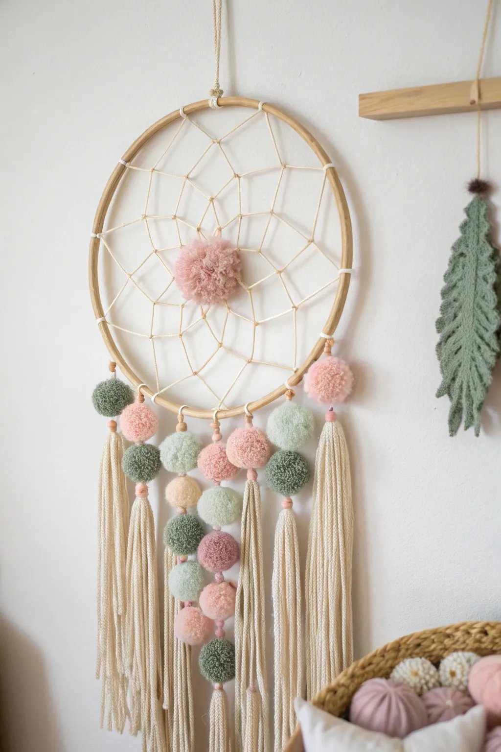Elevate your space with a Pom Pom Dreamcatcher: a perfect blend of Scandinavian simplicity and boho charm.
