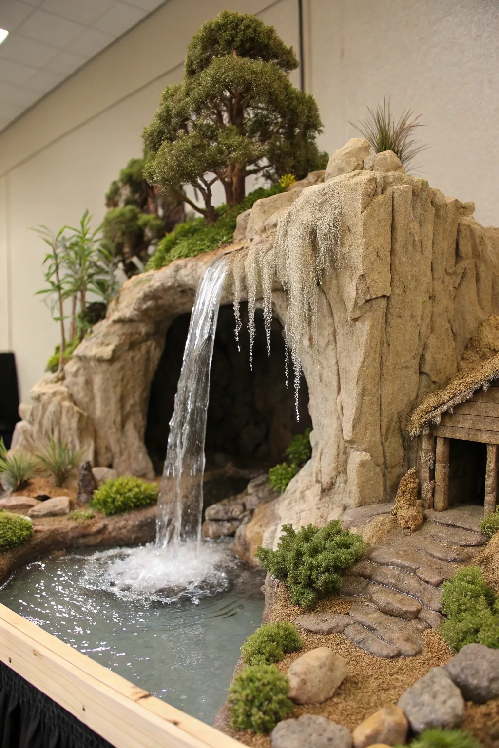 Discover the enchanting allure of nature with a handcrafted waterfall diorama, where cascading waters meet the mystery of a stalactite-adorned cave.
