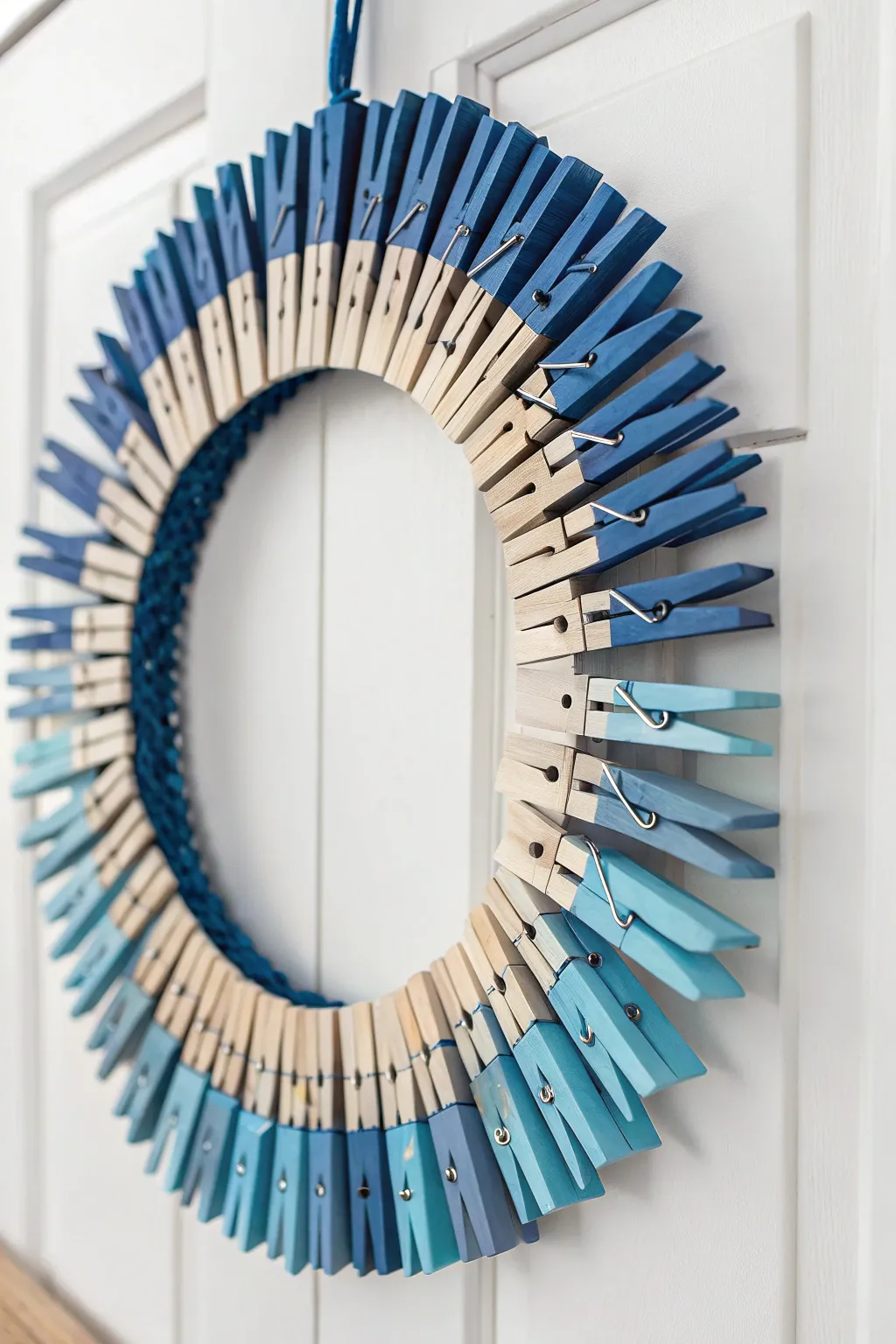 Dive into tranquility with this ombre clothespin wreath, where oceanic hues meet minimalist elegance.