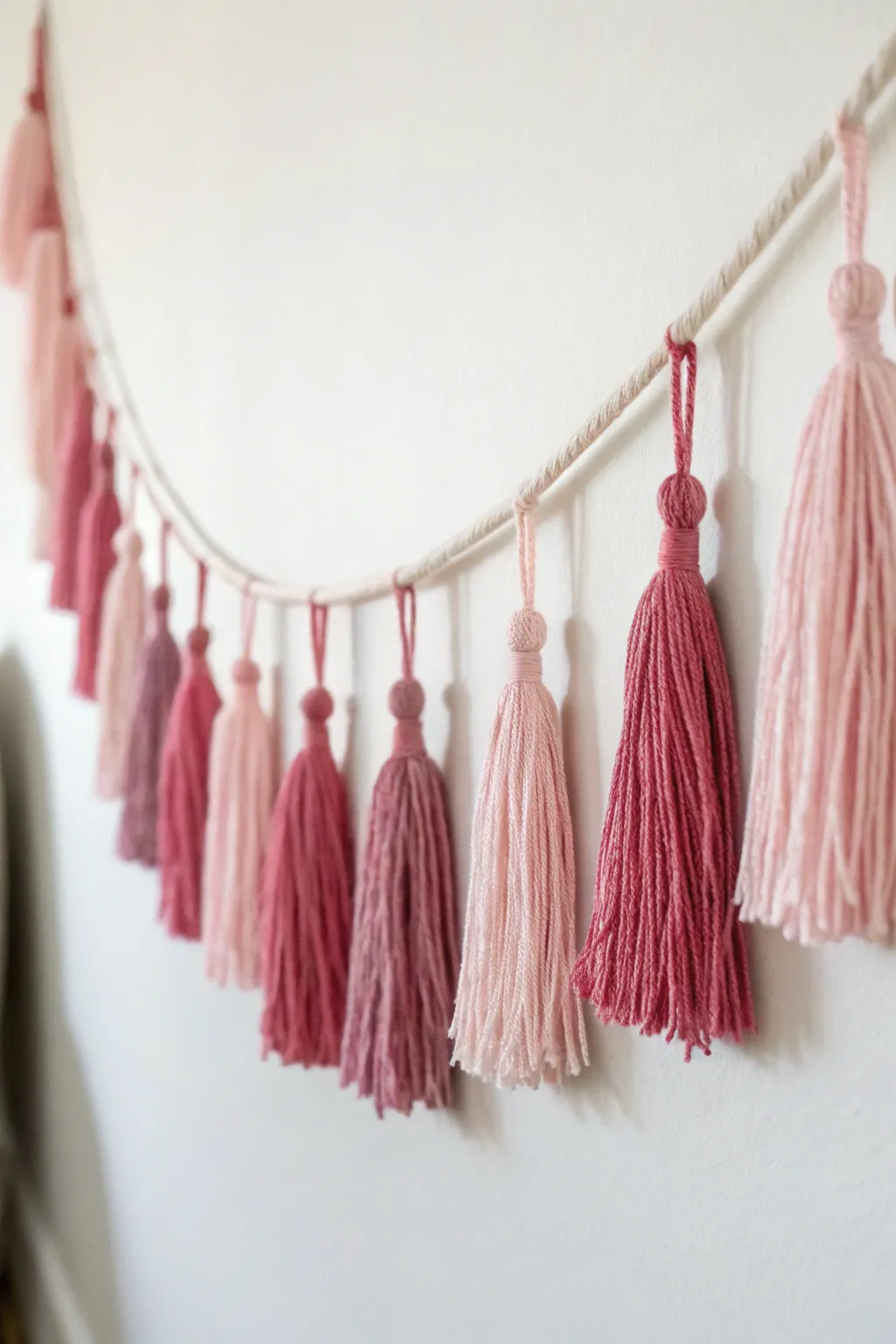 Add a whimsical touch to your space with a handmade tassel garland – simple, elegant, and perfectly pink!