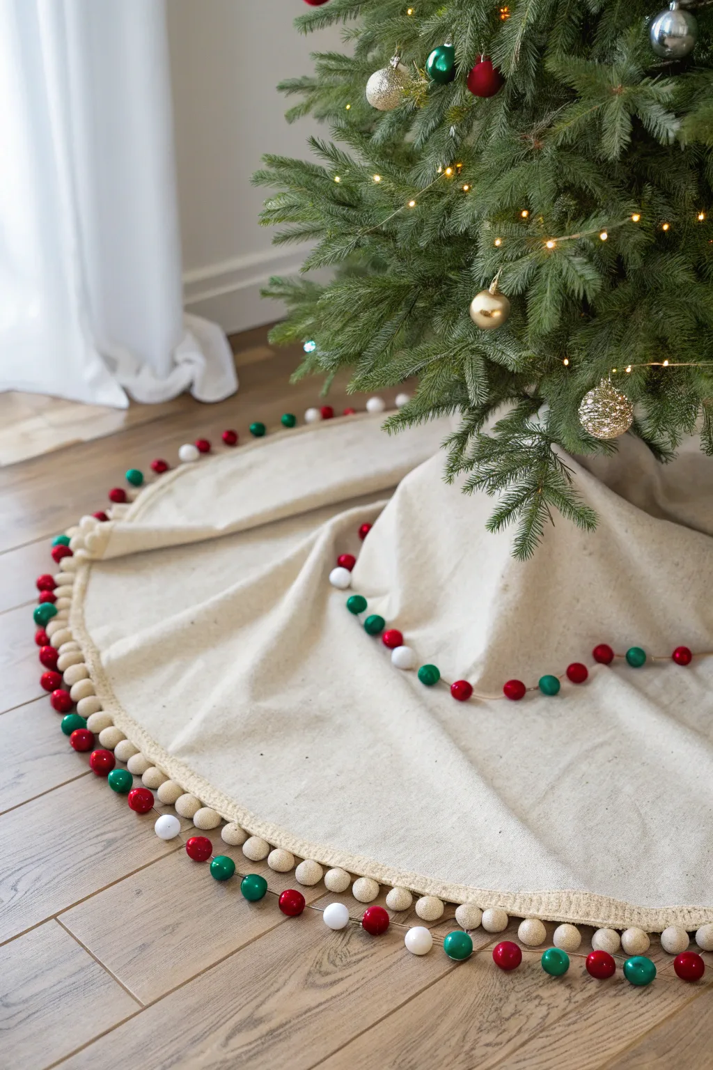 Add a playful pop of color to your holiday decor with this charming pom pom tree skirt!