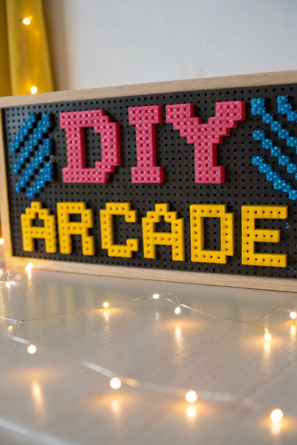 Light up your game room with a charming DIY arcade sign made from Perler beads, perfect for adding a retro flair with a touch of Scandinavian minimalism.