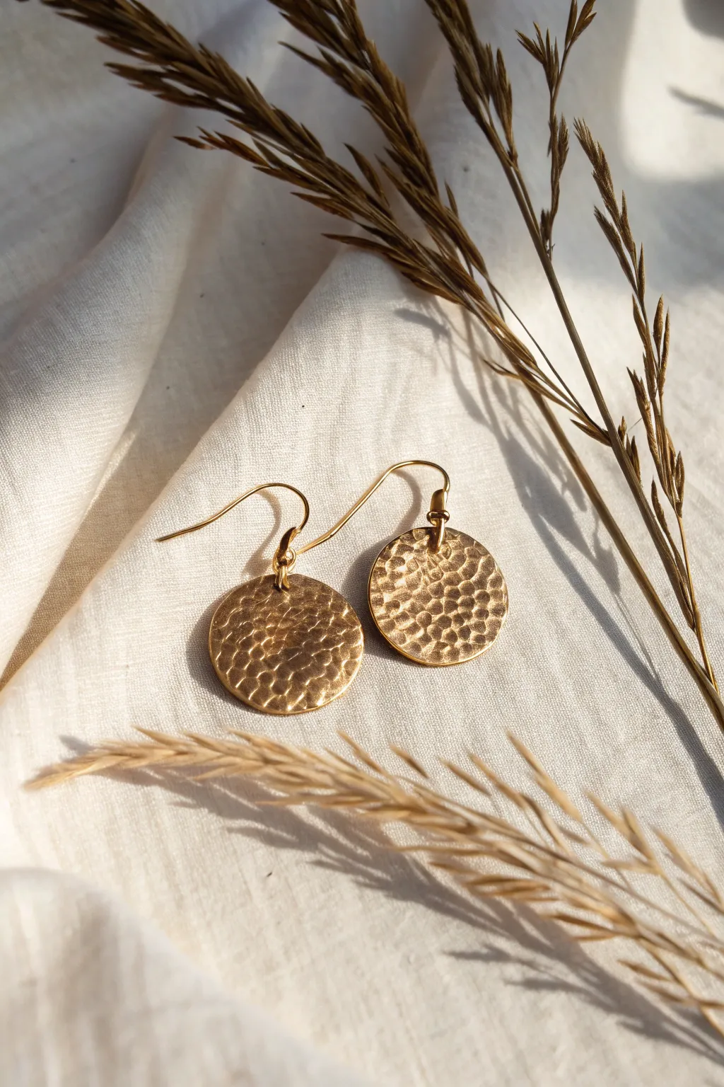 Elevate your style with textured metal earrings that blend craftsmanship with natural beauty.