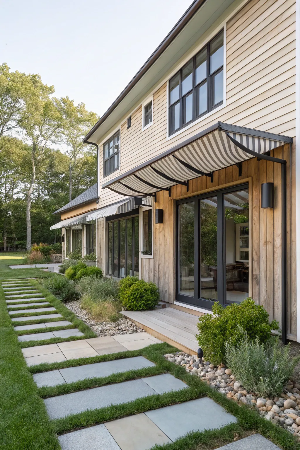 Contemporary slatted awnings add a stylish touch to this modern farmhouse.