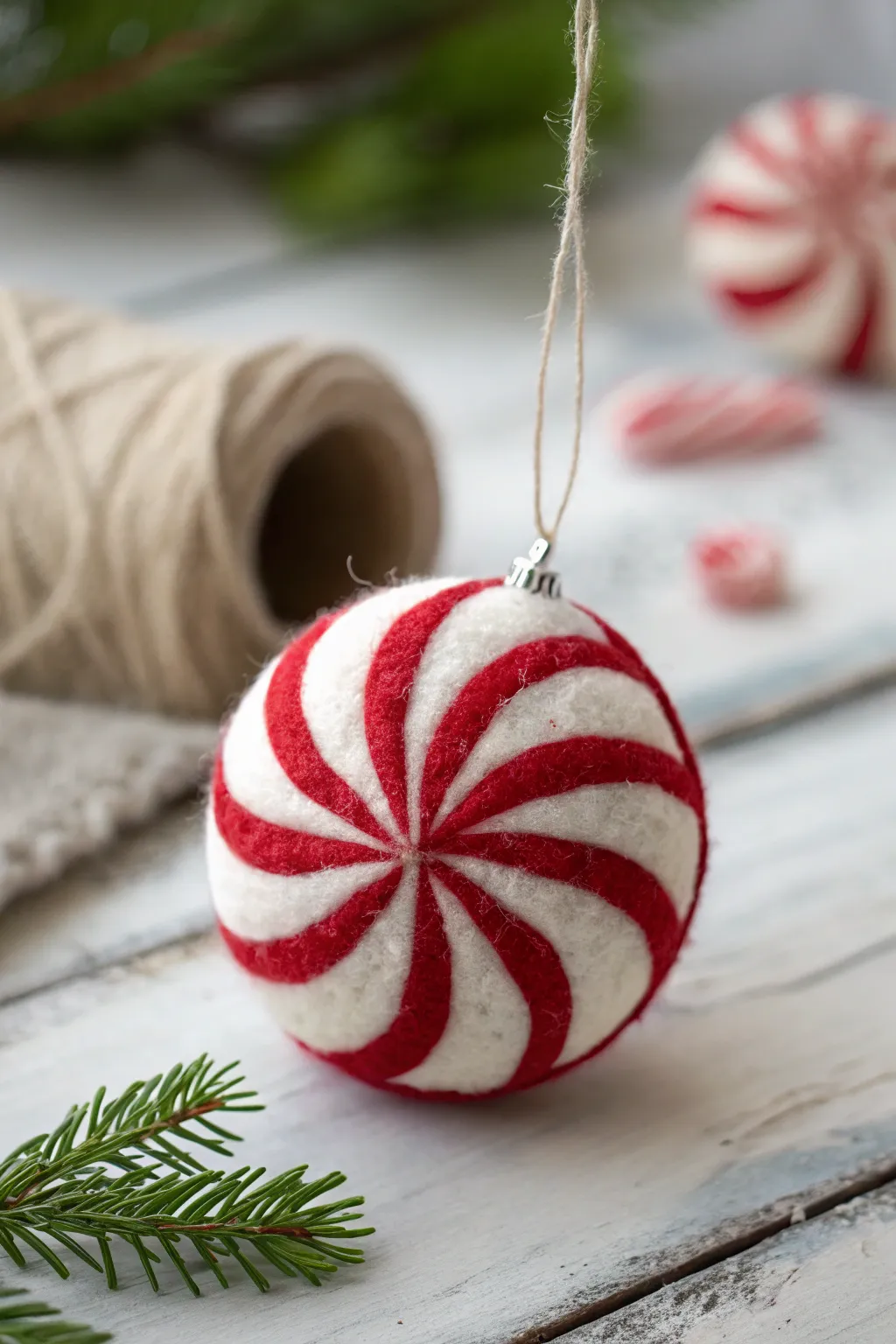 Sweeten your holiday decor with this charming needle-felted peppermint ornament, a perfect blend of Scandinavian minimalism and Boho flair.