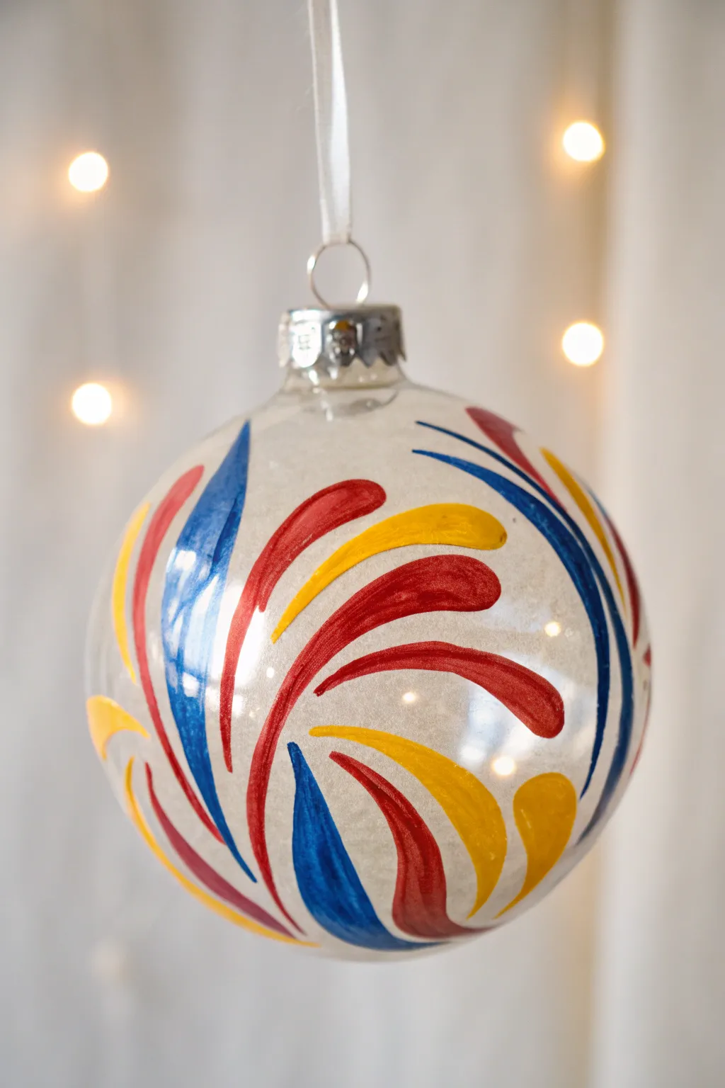 Unleash your creativity with bold, abstract designs on clear ornaments.