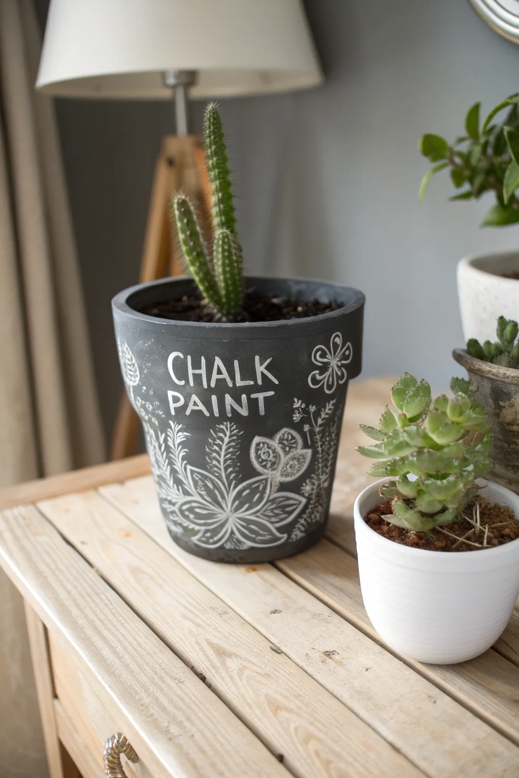 Express your creativity with ever-changing designs on this charming chalkboard clay planter.