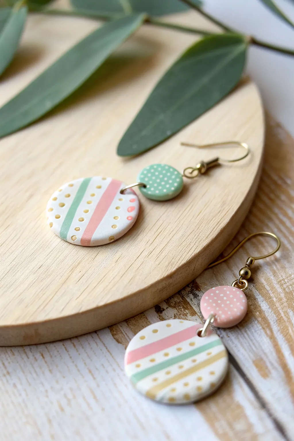 Add a playful touch to your outfit with these charming striped and dotted polymer clay earrings, perfect for the minimalist at heart.