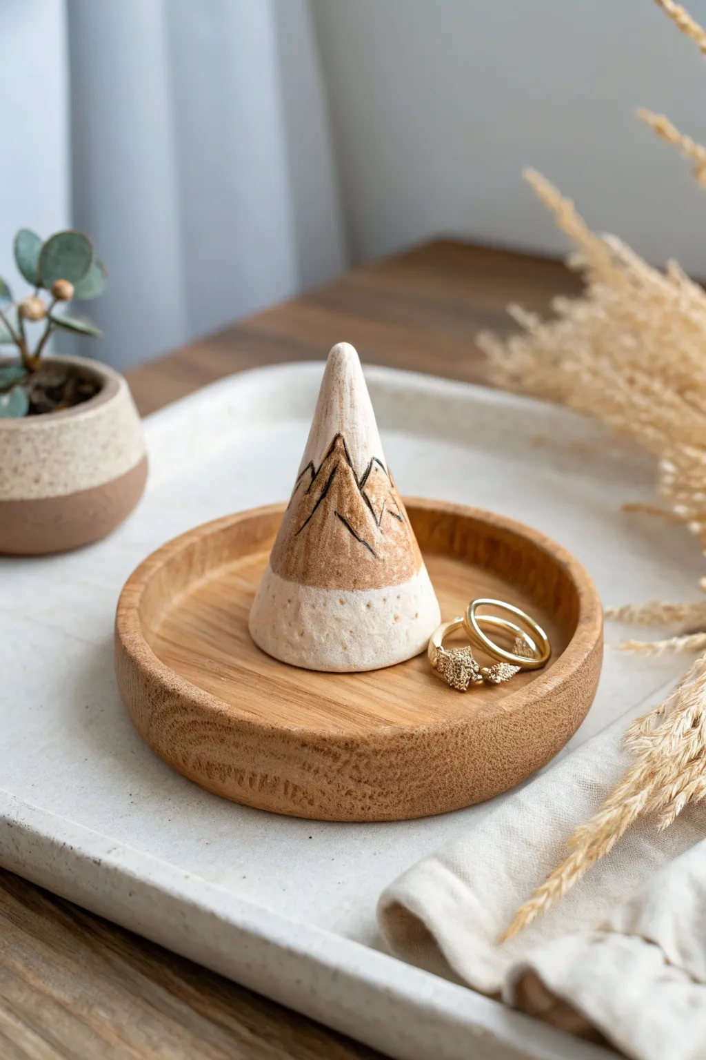 Add a touch of artistry to your vanity with this minimalist polymer clay ring holder, crafted to resemble a serene mountain landscape.