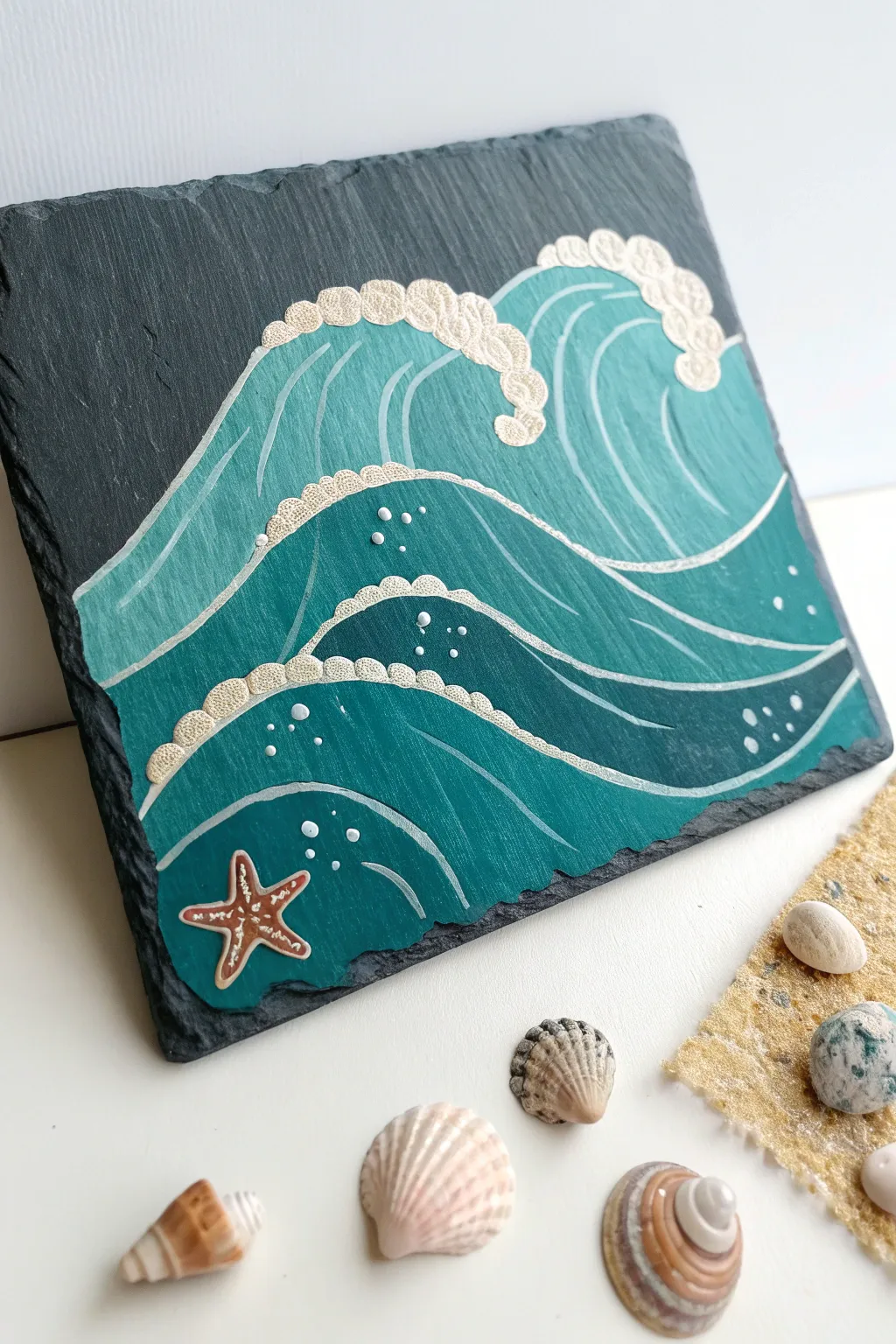Capture the serenity of the sea with this minimalist ocean-inspired slate painting. A touch of beach bliss for your home.
