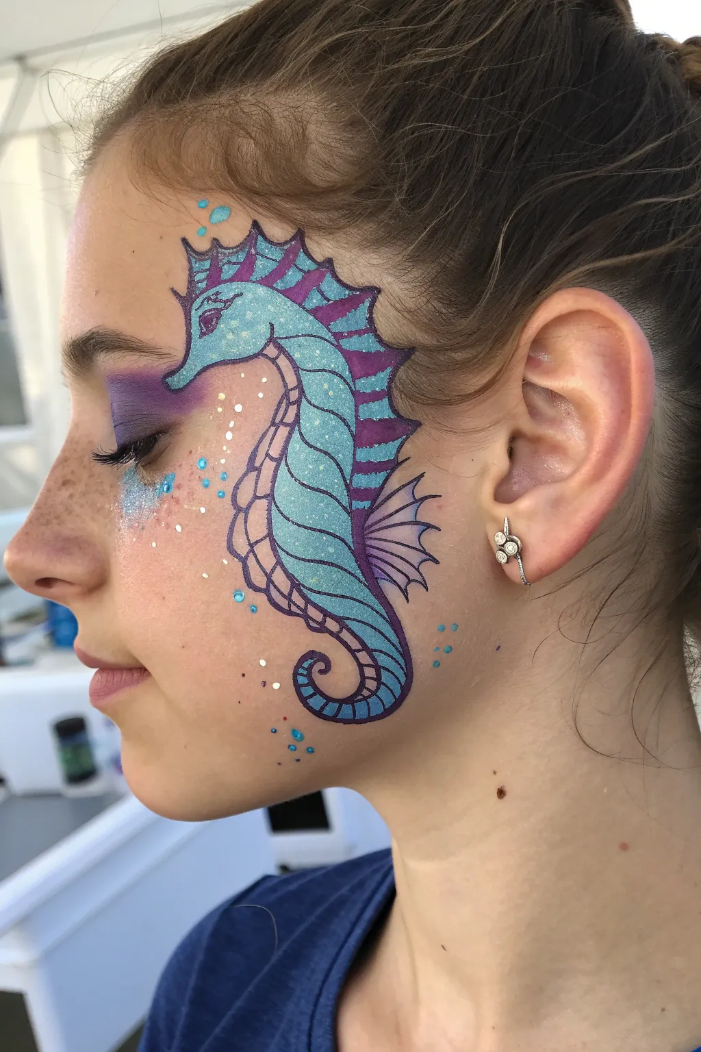 Dive into whimsy with a vibrant seahorse face paint, capturing the enchanting hues of the sea.