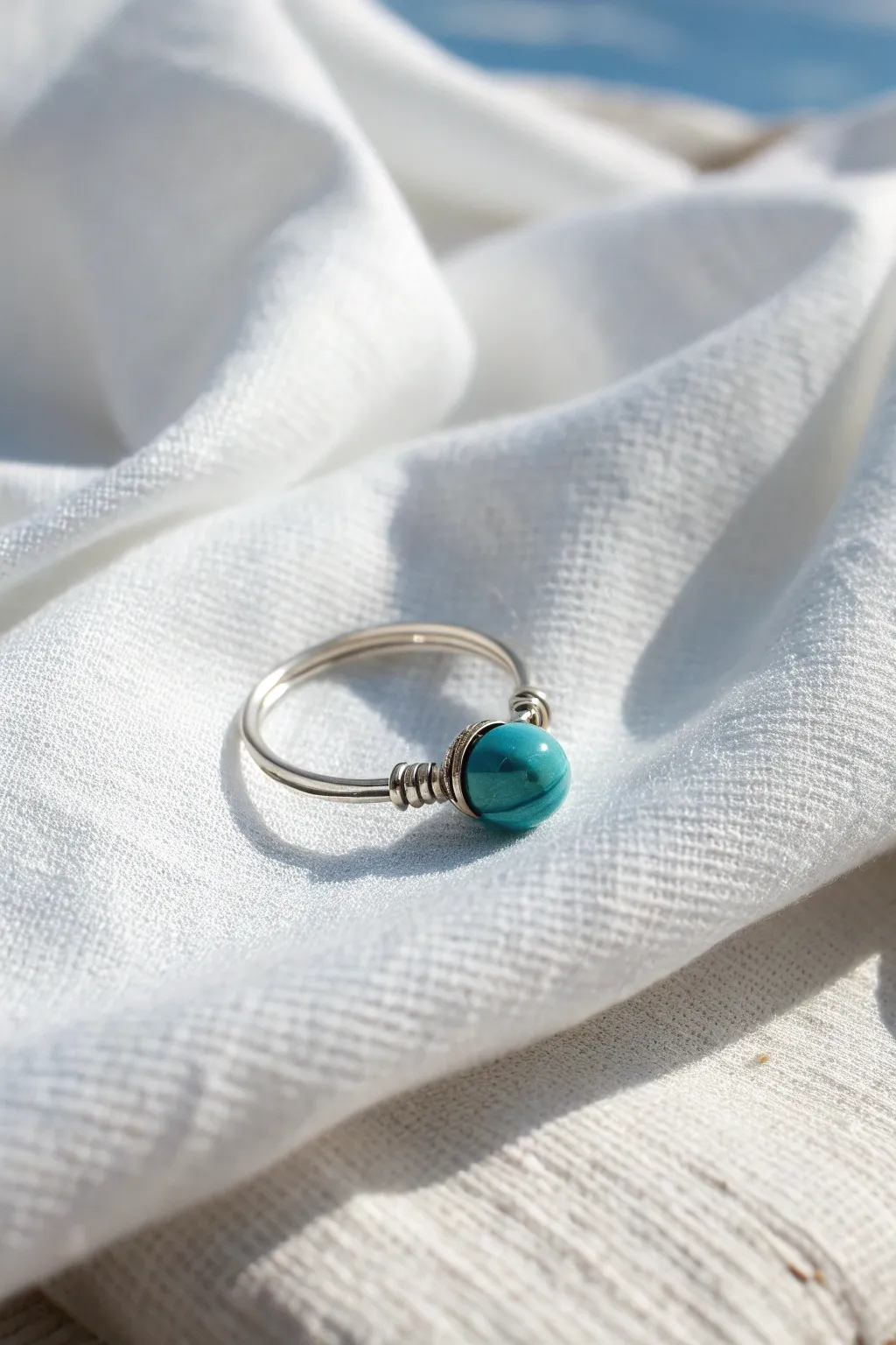 Embrace simplicity with a touch of color – a wire ring with a turquoise twist.