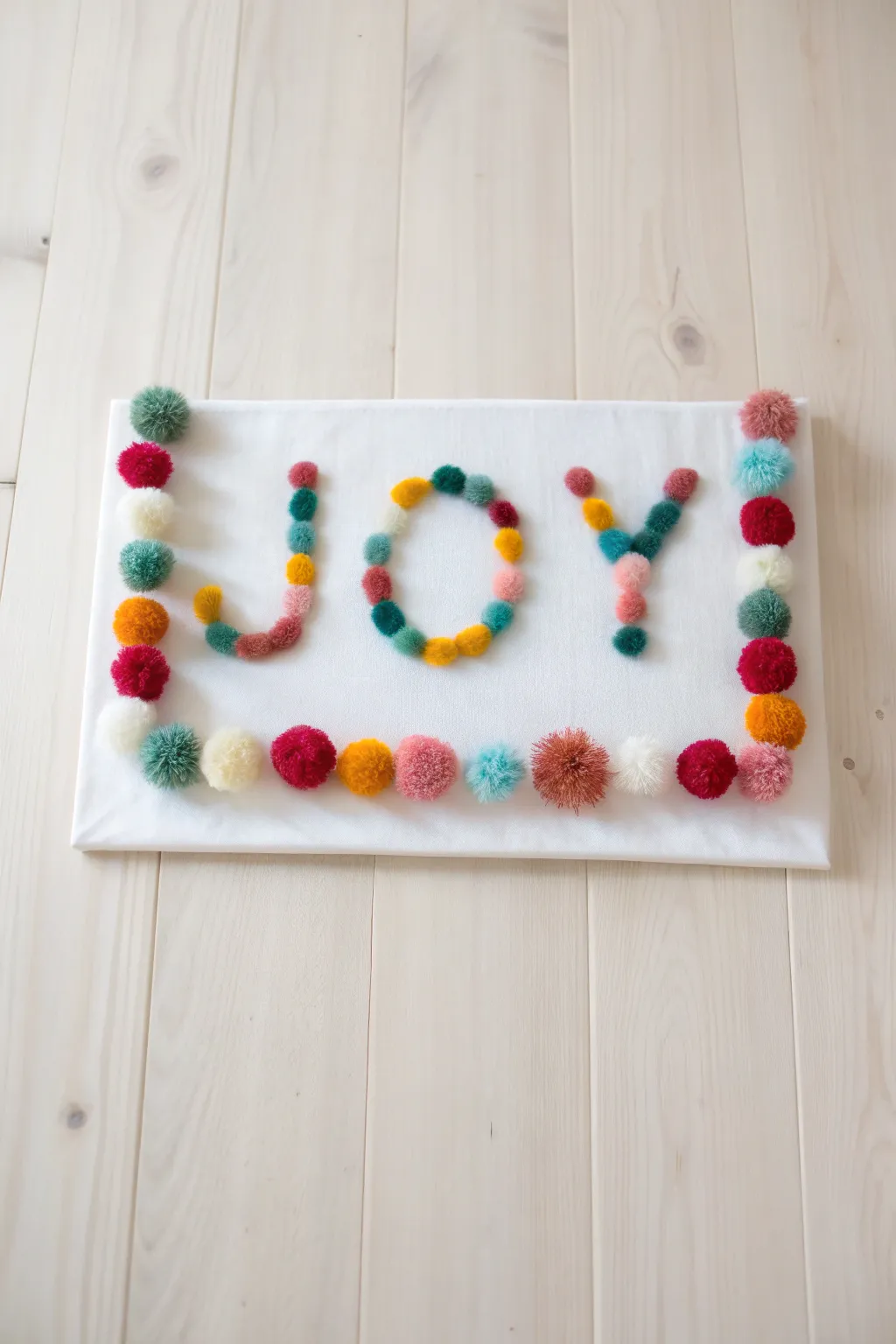 Bring joy to your mantel with a simple yet stunning pom pom craft!