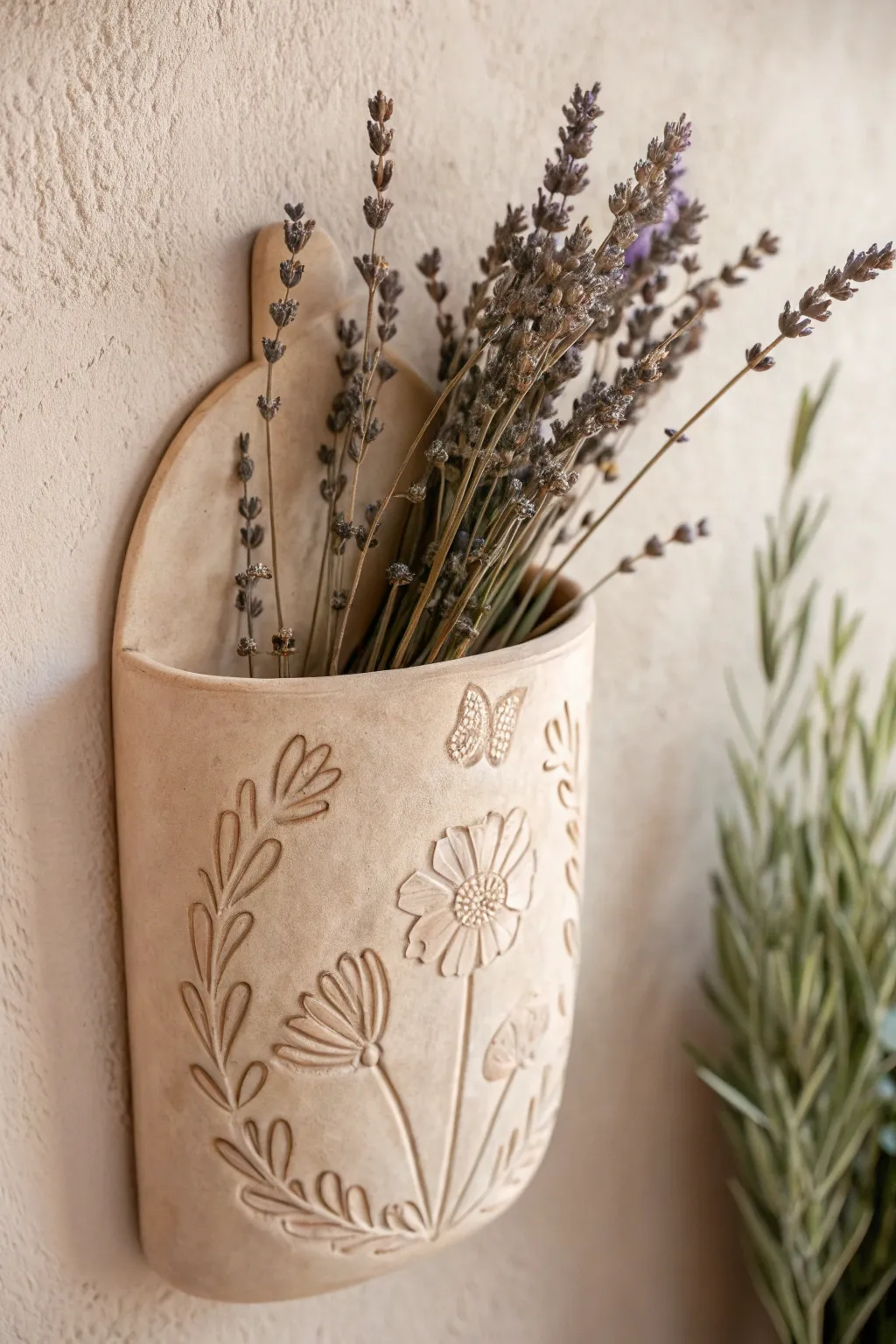 Embrace simplicity and elegance with a handcrafted clay floral wall pocket, perfect for adding a touch of Boho charm to your space.