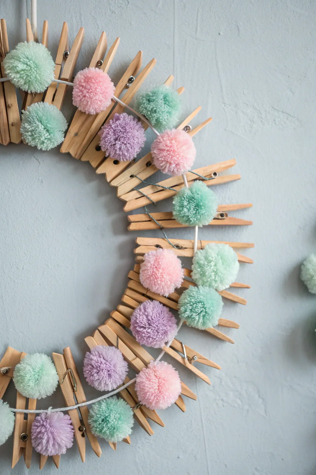 Add a pop of playfulness to your decor with a pom-pom adorned clothespin wreath!