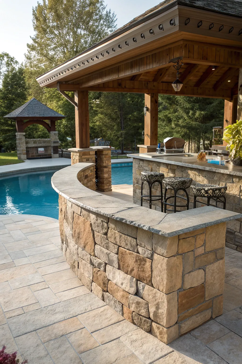 Elevate your poolside with the timeless elegance of a natural stone bar.