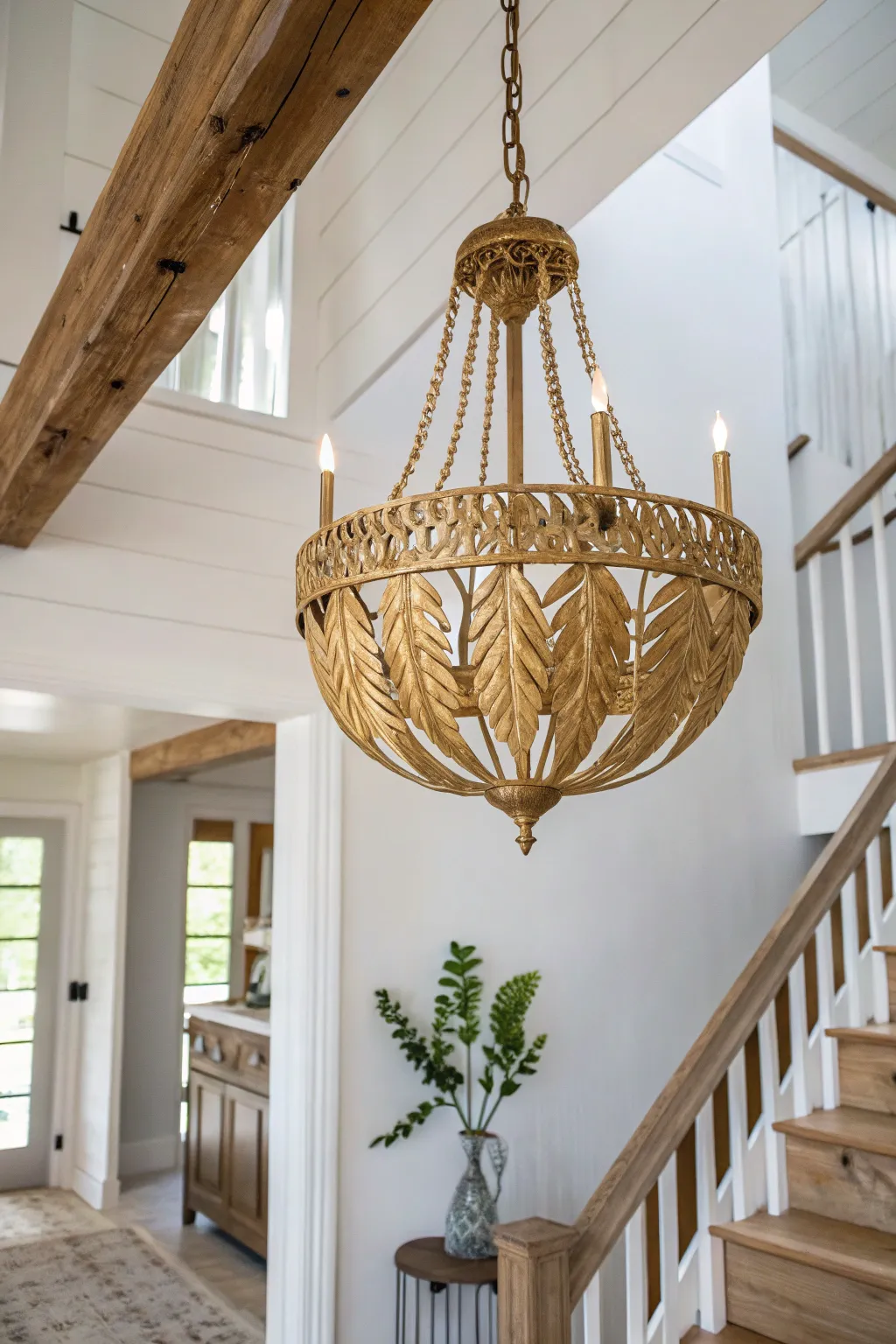 Transform your entryway with a touch of luxury—our gold leaf chandelier makeover brings elegance to minimalist beauty.