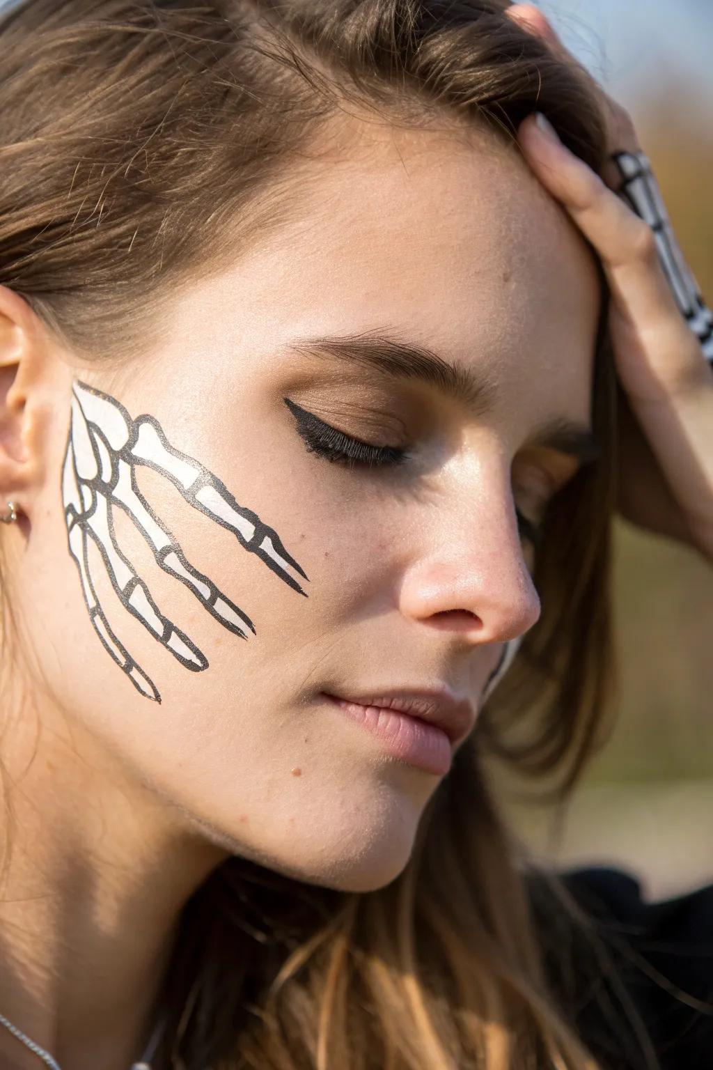 Embrace the simplicity and intrigue of minimalist skeleton hands face paint for a chic and spooky look.
