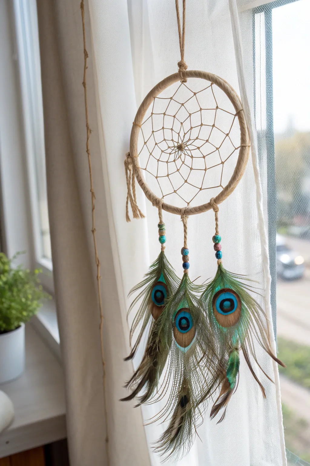 Embrace tranquility with a handcrafted peacock feather dreamcatcher, where simplicity meets natural elegance.