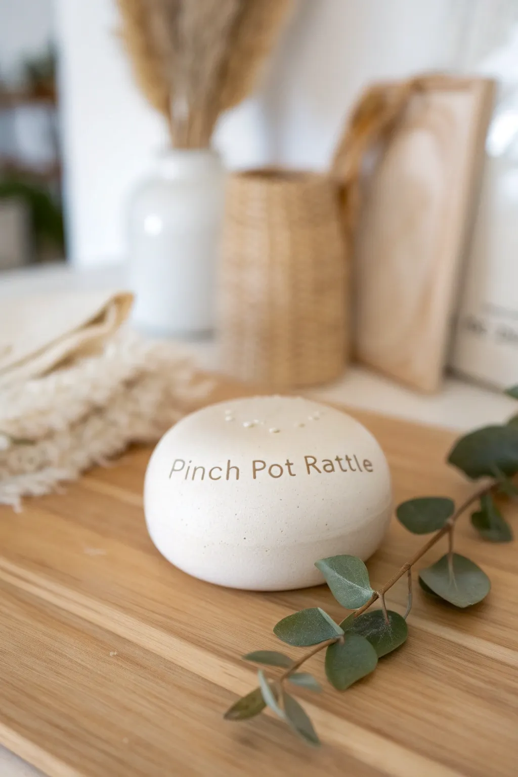 Whispered Secrets: A handcrafted pinch pot rattle with a hidden message, perfect for cherishing meaningful moments.