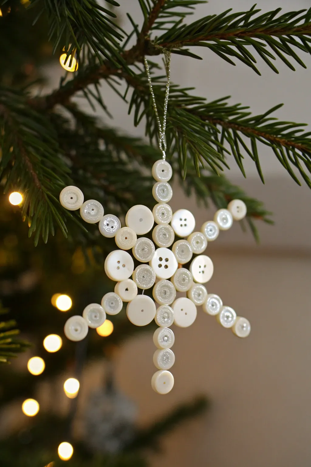 Capture the magic of winter with these beautifully crafted button snowflakes, a perfect blend of simplicity and charm for your Christmas tree.