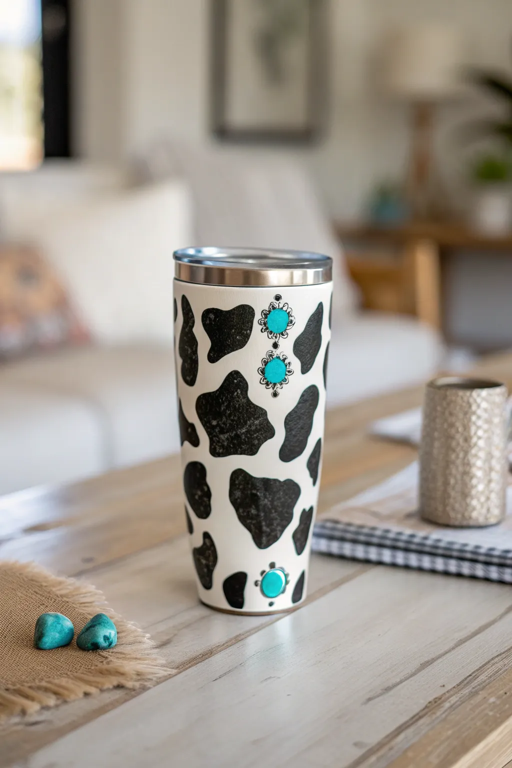 Elevate your style with a cow print tumbler adorned with turquoise stones – a perfect blend of elegance and natural beauty.