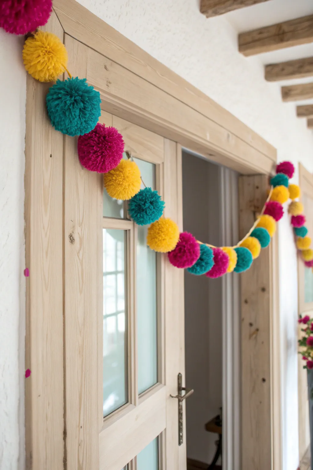 Add a playful pop of color to your home with a handcrafted pom-pom garland.