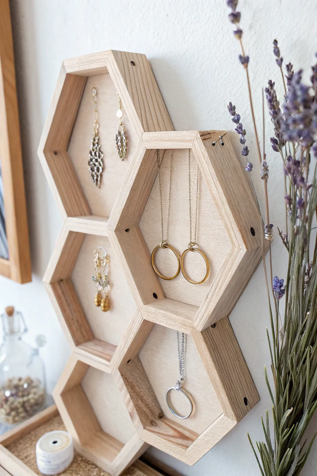 Organize your treasures with Scandinavian elegance: a minimalist honeycomb jewelry display.