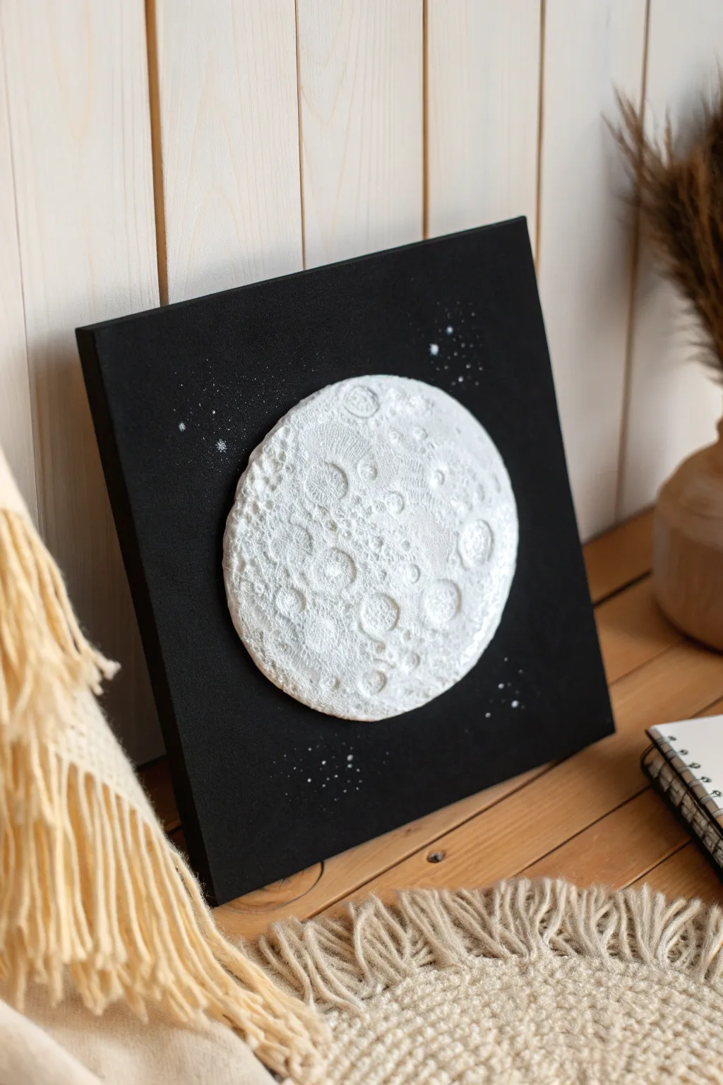 Craft a stunning 3D moon with puffy paint for a minimalist yet enchanting art piece.