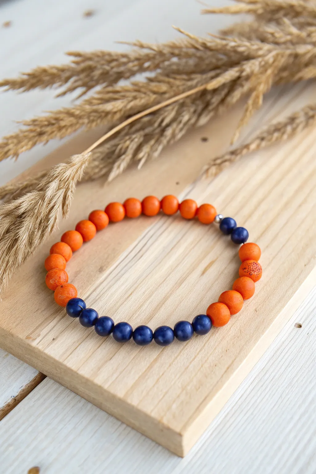Embrace the mystical allure of deep blue and vibrant orange in this stunning clay bead bracelet.